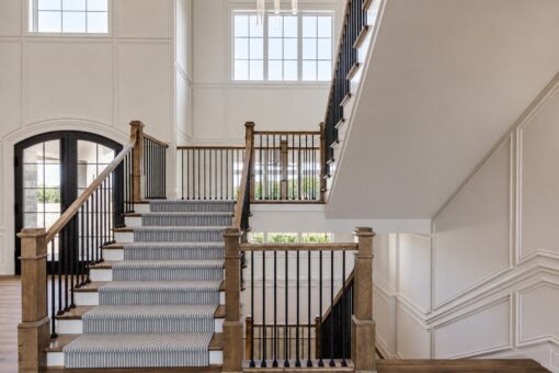 Ridge staircase with carpet runner and arched doors