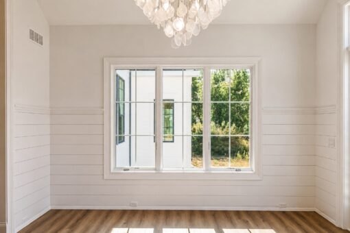 Ridge sunroom with shiplap walls and chandelier
