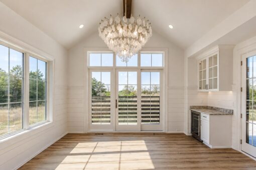 Ridge sunroom with vaulted ceiling and French doors