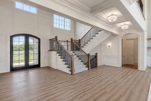 Ridge two-story foyer with arched iron entry doors and open staircase