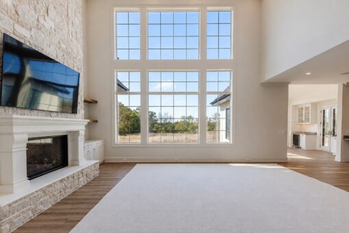 Ridge two-story great room with window wall and stone fireplace