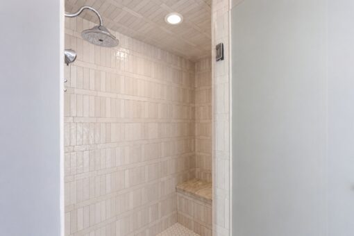 Ridge walk-in shower with stacked tile and bench